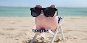 booster-blog-kiwisaver-after-65-piggy-bank-on-beach-chair-new-zealand